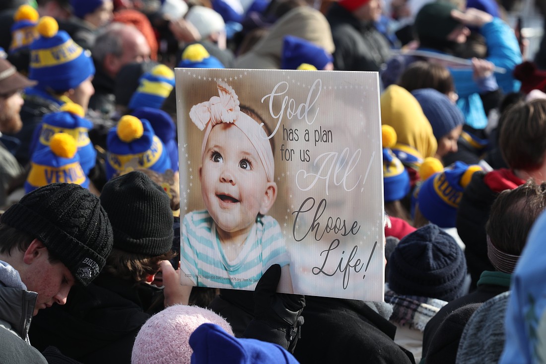 An attendee holds a poster during the 52nd annual March for Life rally in Washington Jan. 24, 2025. (OSV News photo/Bob Roller)