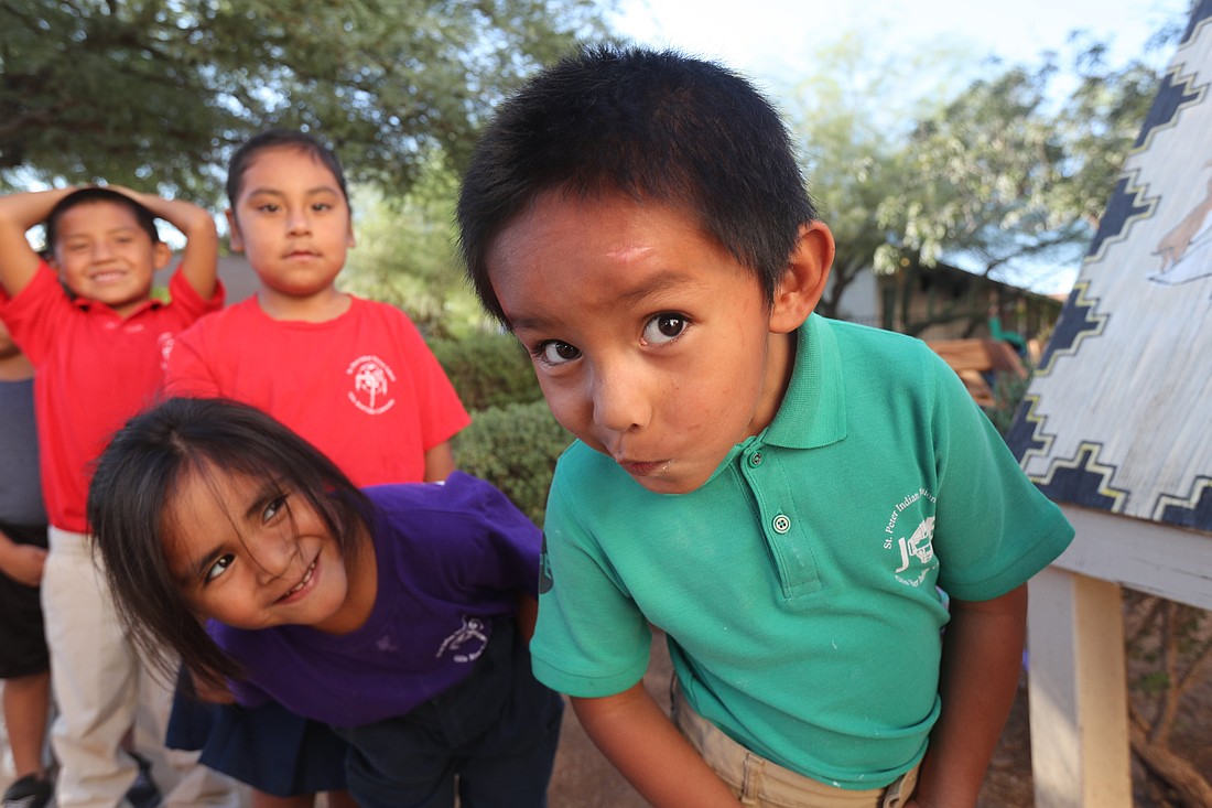 Elana Sanchez looks at Jarramiyah Lewis as he looks into the camera at St. Peter Indian Mission Catholic School on the Gila River Indian Reservation in Bapchule, Ariz. The school is a mission of the Franciscan Sisters of Christian Charity out of Manitowoc, Wis., and was established in 1923. (OSV News photo/Bob Roller)