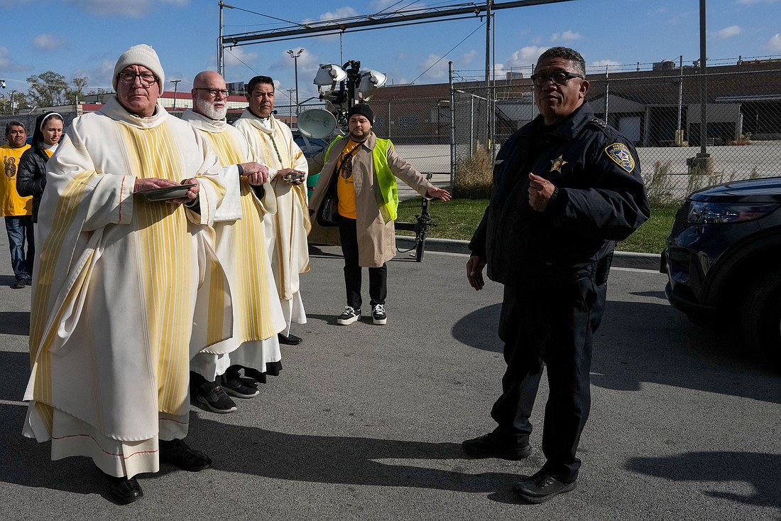 Law enforcement officers prevent clergymen from entering the Broadview ICE facility to offer Communion to immigrants detained inside during an outdoor Mass in the Chicago suburb of Broadview, Ill. The Mass was celebrated by Chicago Auxiliary Bishop José María Garcia-Maldonado. (OSV News photo/Leah Millis, Reuters)