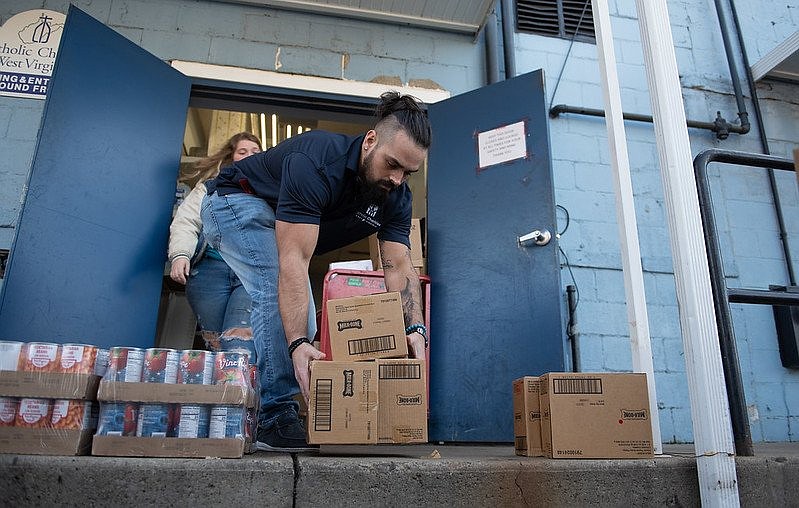 A volunteer with the Society of St. Vincent de Paul USA is pictured in an undated photo unloading aid for people in need. (OSV News photo/courtesy Society of St. Vincent de Paul USA)