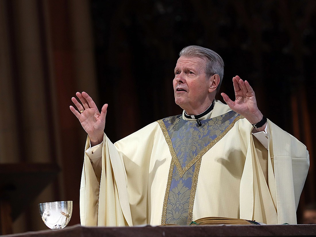 Bishop Edward Scharfenberger prepares for communion during Easter Mass at the Cathedral of the Immaculate Conception.
