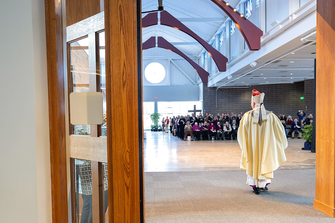 Bishop Mark O'Connell shows the Apostolic Mandate to the faithful after he is installed as the 11th Bishop of Albany (Patrick Dodson photo)