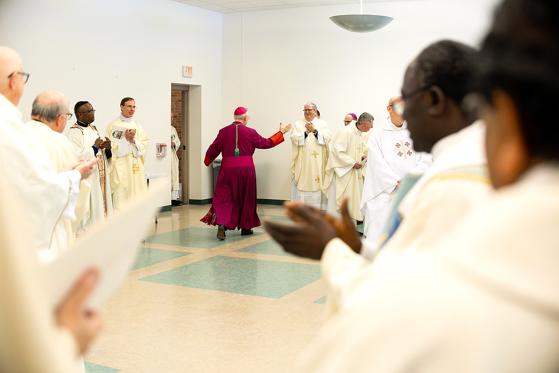 Bishop Mark W. O'Connell shares a laugh with priests and deacons before his Installation Mass at St. Edward the Confessor in Clifton Park on Friday, December 5, 2025. (Patrick Dodson photo)