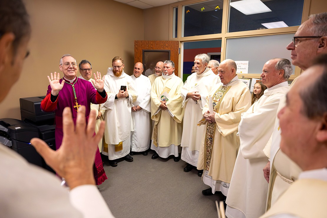 Bishop Mark W. O'Connell shares a laugh with priests and deacons before his Installation Mass at St. Edward the Confessor in Clifton Park on Friday, December 5, 2025. (Patrick Dodson photo)