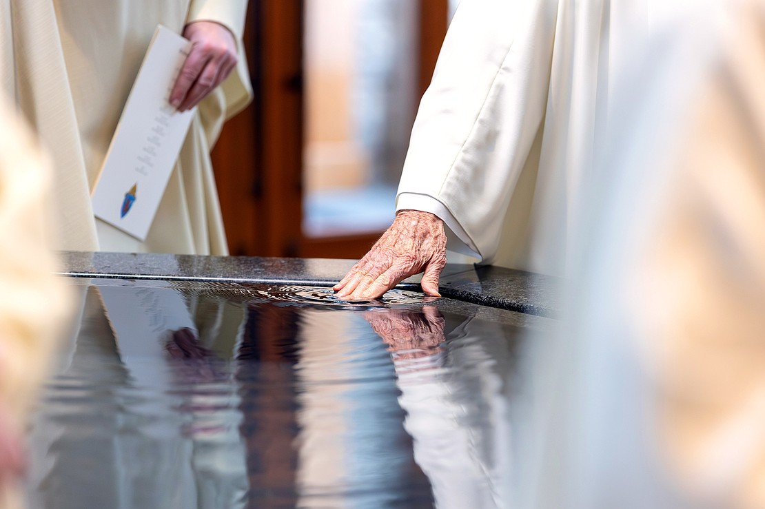 Priests dip the fingers into holy water before the Installation Mass of Bishop Mark O'Connell at St. Edward the Confessor in Clifton Park on Friday, December 5, 2025. (Patrick Dodson photo)