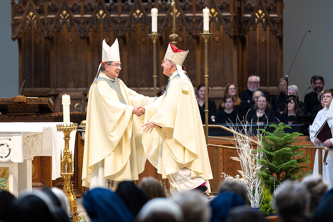 Bishop Mark W. O'Connell (r.) shakes hands with Cardinal Christophe Pierre, Apostolic Nuncio to the United States, after he read the Apostolic Mandate. (Patrick Dodson photo)