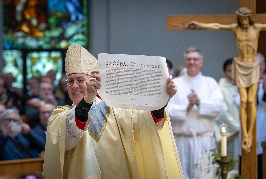 Bishop Mark O'Connell shows off the Apostolic Mandate naming him the 11th Bishop of Albany during his Installation Mass on Dec. 5. (Dino Petrocelli photos for The Evangelist)