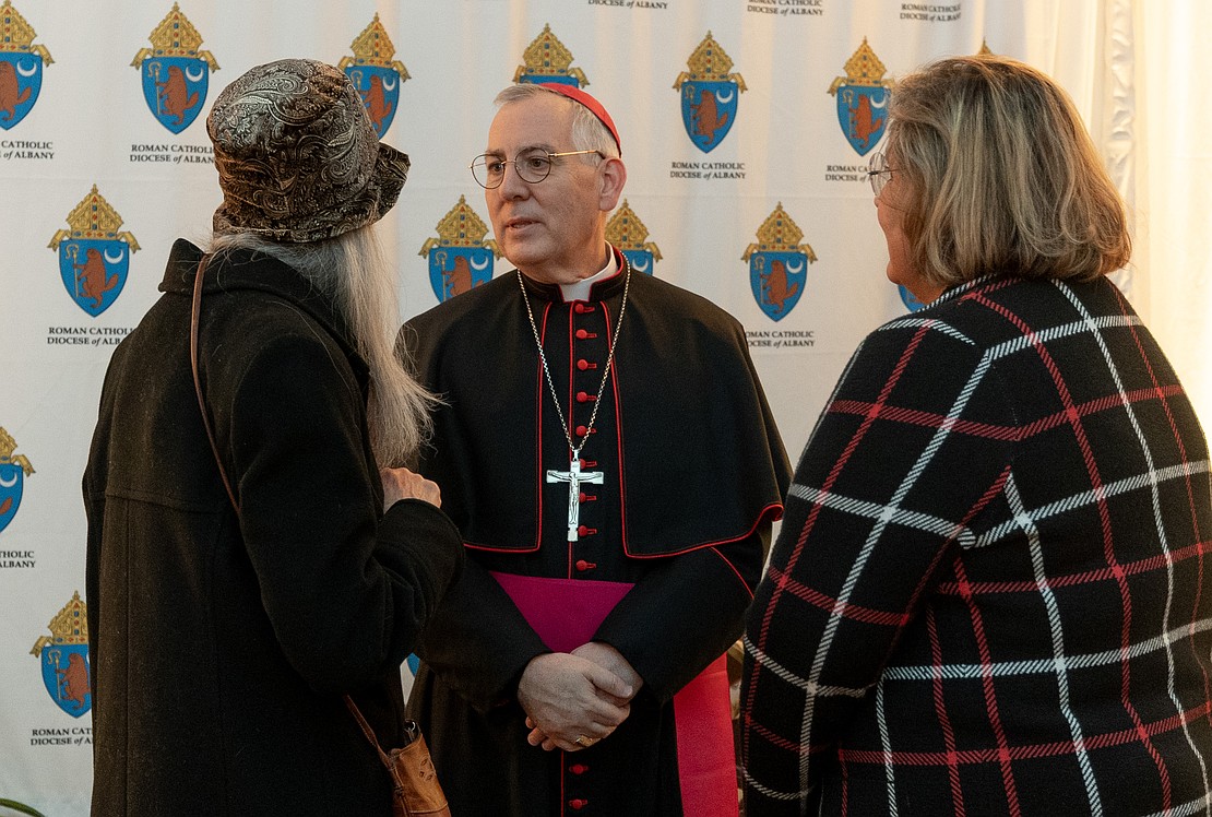 Bishop Mark O'Connell meets with the faithful in a heated tent after his Installation Mass. (Dino Petrocelli photos for The Evangelist)
