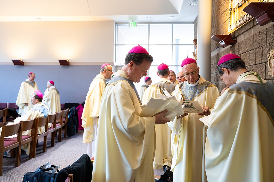 St. Edward the Confessor Church was a din of activity - priests and bishops getting vested, old friendships were renewed, and there were lots of hugs and lots of work still to be done - prior to Bishop Mark O'Connell's Installation Mass. (Patrick Dodson photo for The Evangelist)