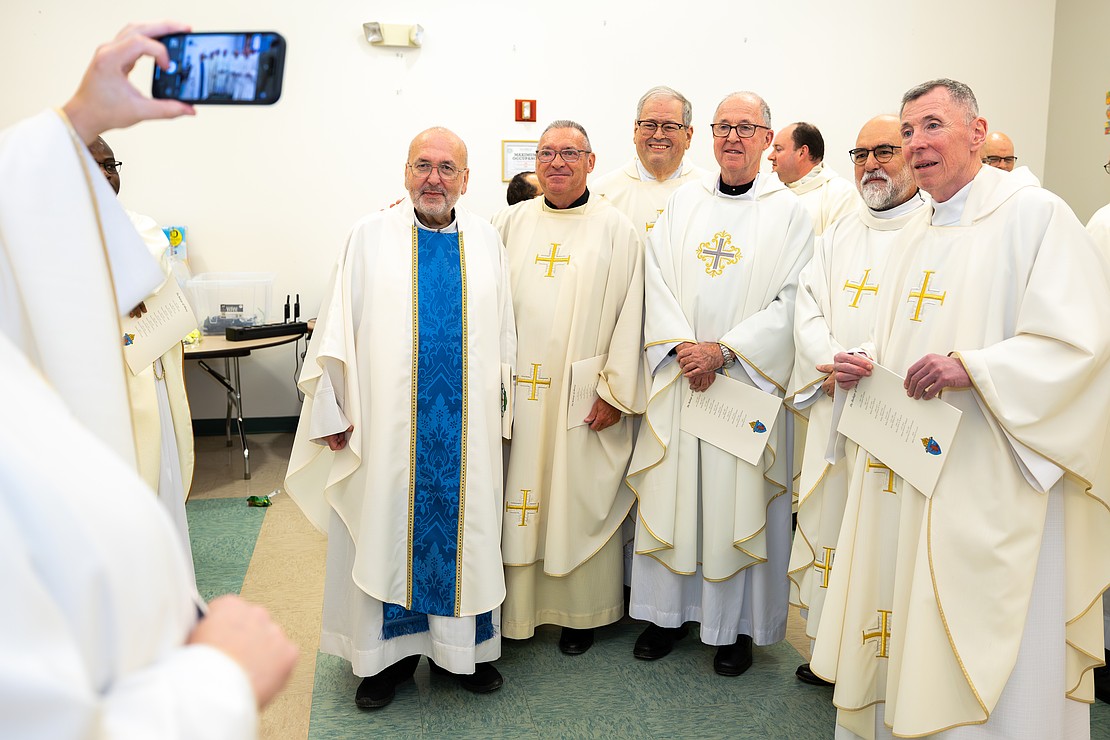 St. Edward the Confessor Church was a din of activity - priests and bishops getting vested, old friendships were renewed, and there were lots of hugs and lots of work still to be done - prior to Bishop Mark O'Connell's Installation Mass. (Patrick Dodson photo for The Evangelist)
