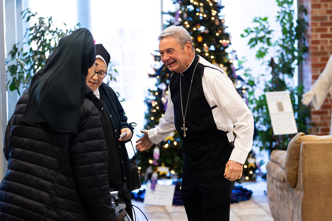 St. Edward the Confessor Church was a din of activity - priests and bishops getting vested, old friendships were renewed, and there were lots of hugs and lots of work still to be done - prior to Bishop Mark O'Connell's Installation Mass. (Patrick Dodson photo for The Evangelist)