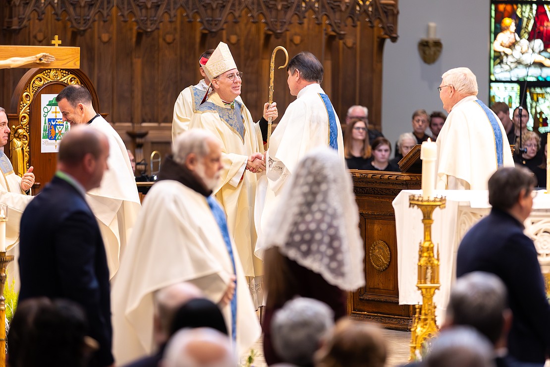 Bishop Mark O'Connell shakes hands with priests, bishops and ecumenical leaders after he is installed as the 11th Bishop of Albany. (Patrick Dodson photo for The Evangelist)