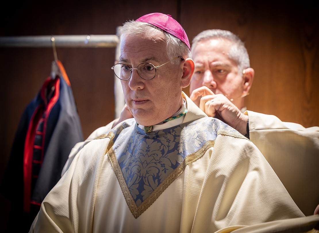 Bishop Mark O'Connell is vested prior to his Installation Mass. (Dino Petrocelli photo for The Evangelist)