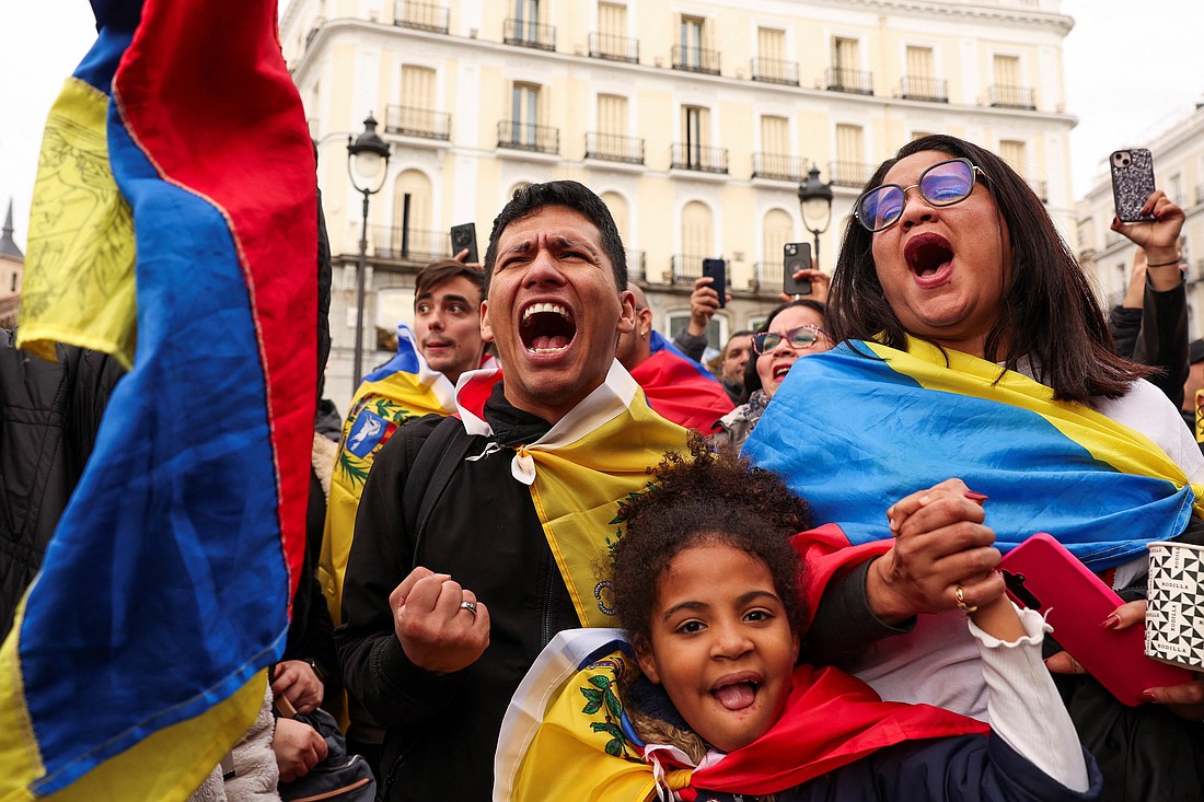 A family celebrates next to a Venezuelan flag in Madrid Jan. 3, 2026, as they react to the news after U.S. President Donald Trump said the U.S. has struck Venezuela and captured its President Nicolas Maduro. (OSV News photo/Violeta Santos Moura)