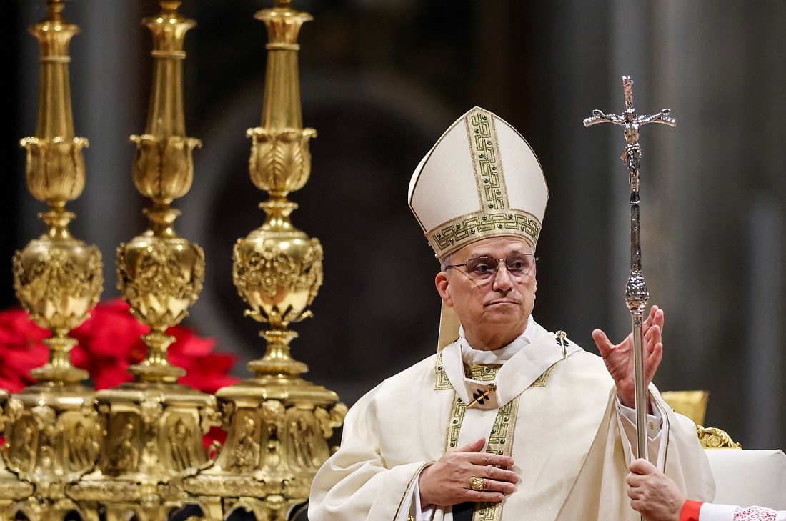 Pope Leo XIV is handed his pastoral staff as he celebrates Mass on the feast of the Epiphany in St. Peter's Basilica at the Vatican Jan. 6, 2026. (OSV News photo/Yara Nardi, Reuters)..