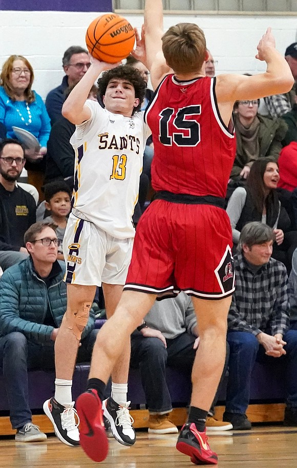 Spa Catholic’s David Redgrave, left, shoots for three points as Tamarac’s Samuel Kuiken defends during their basketball game on Friday, Jan. 9, 2026, at Saratoga Catholic Central School in Saratoga Springs, N.Y. Spa Catholic wins 63-58.  Cindy Schultz for The Evangelist