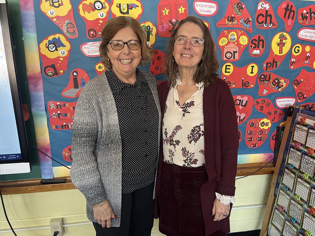 Megan Smith (r.) credits her colleagues, administrative staff and the parents of St. Pius X for making the school so special, and in particular her teaching assistant, Jean John, who’s been with her since she joined the school. (Emily Benson photo)