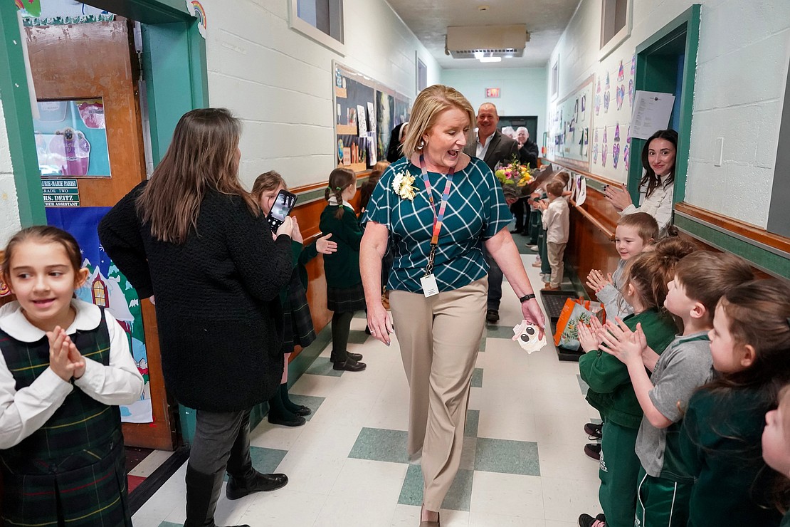 Principal Kris Hoffay, named 2026 Principal of the Year, center, walks through the hallway as students cheer for her on Friday, Jan. 23, 2026, at St. Jude the Apostle School in Wynantskill, N.Y.  Cindy Schultz for The Evangelist