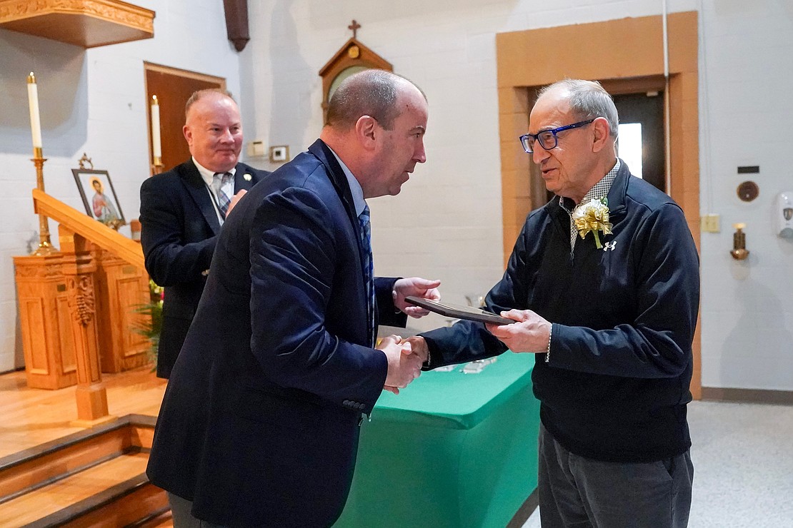 James Morrell, right, receives the St. John Newmann Award for Commitment to Catholic Education from superintendent of schools Christopher Bott, left, during the Catholic Schools mass on Friday, Jan. 23, 2026, at St. Jude the Apostle Church in Wynantskill, N.Y.  Cindy Schultz for The Evangelist