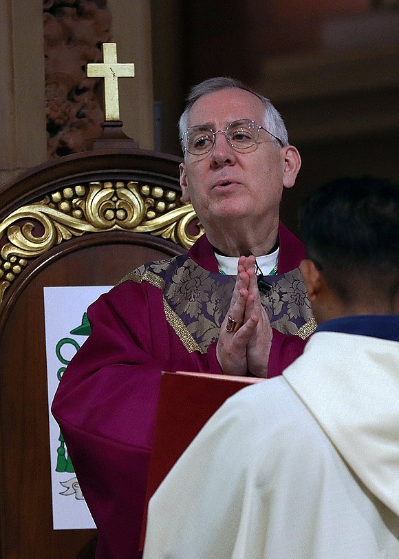 Bishop Mark O'Connell prays during the Ash Wednesday service at the Cathedral of the Immaculate Conception on Feb. 18. (Thomas Killips photo)