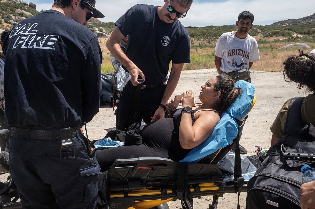 A pregnant migrant from Brazil is treated and taken away by medics at a temporary staging area, in Jacumba Hot Springs, Calif., June 4, 2024. (OSV News photo/Go Nakamura, Reuters).