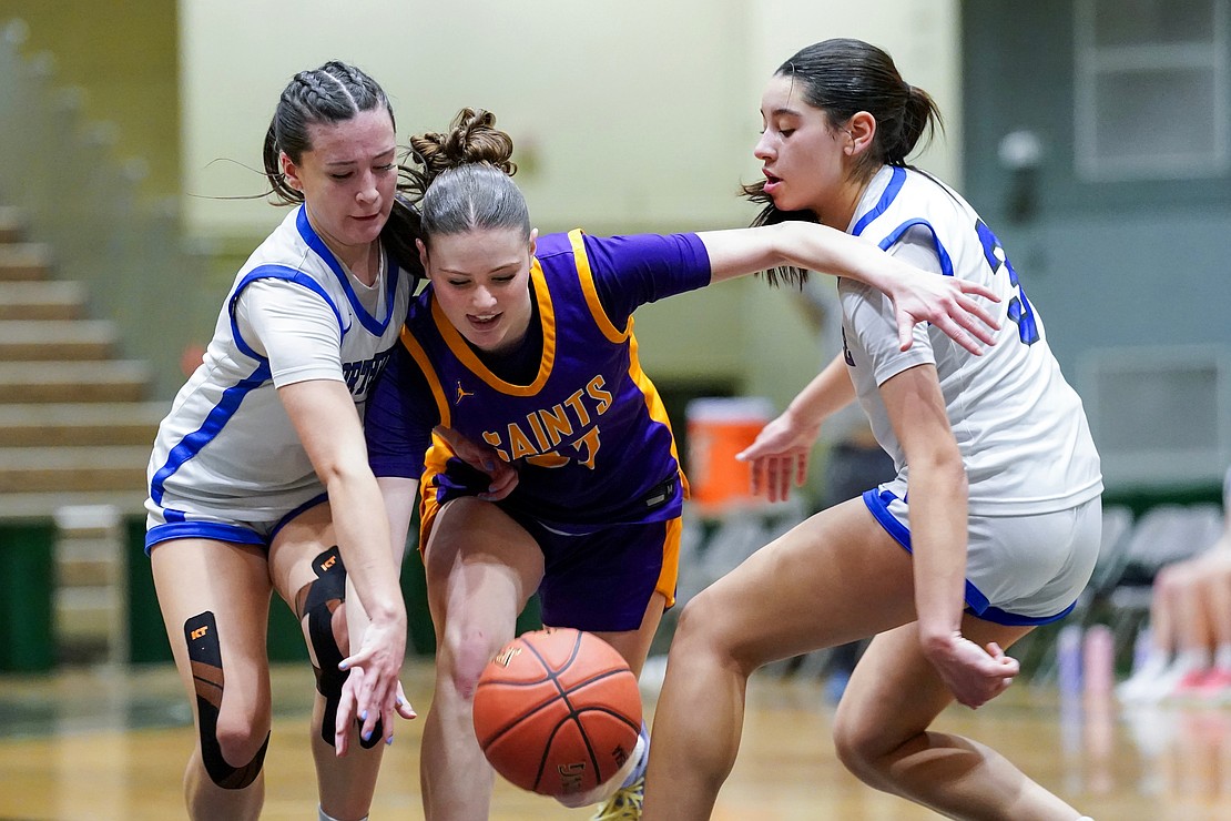 Saratoga Catholic’s Sophia Ryan, center, fights for control of the ball against Northville’s Zoey Jensen, left, and Izzy Colon, right, during their Section II Class D final basketball game on Saturday, March 7, 2026, at Hudson Valley Community College in Troy, N.Y. Saratoga Catholic wins 43-41.  Cindy Schultz for The Evangelist