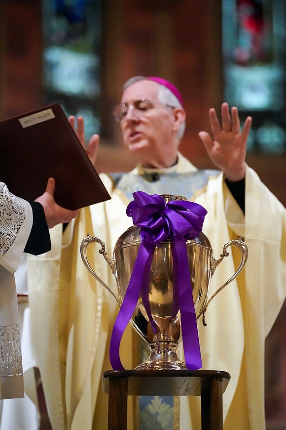 Bishop Mark O’Connell, center, presides over the Chrism Mass on March 30 at the Cathedral of Immaculate Conception in Albany. (Cindy Schultz photo for The Evangelist)