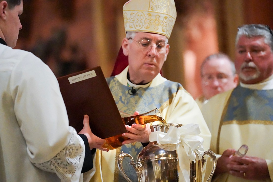 Bishop Mark O’Connell adds balsam to the Holy Chrism during the Chrism Mass on March 30 at the Cathedral of Immaculate Conception in Albany. (Cindy Schultz photo for The Evangelist)