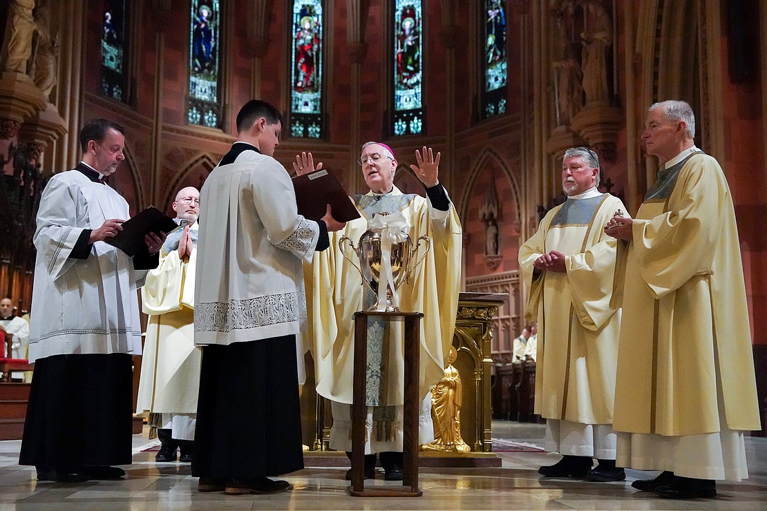 Bishop Mark O’Connell (c.) presides over the Chrism Mass on March 30 at the Cathedral of Immaculate Conception in Albany. (Cindy Schultz photo for The Evangelist)