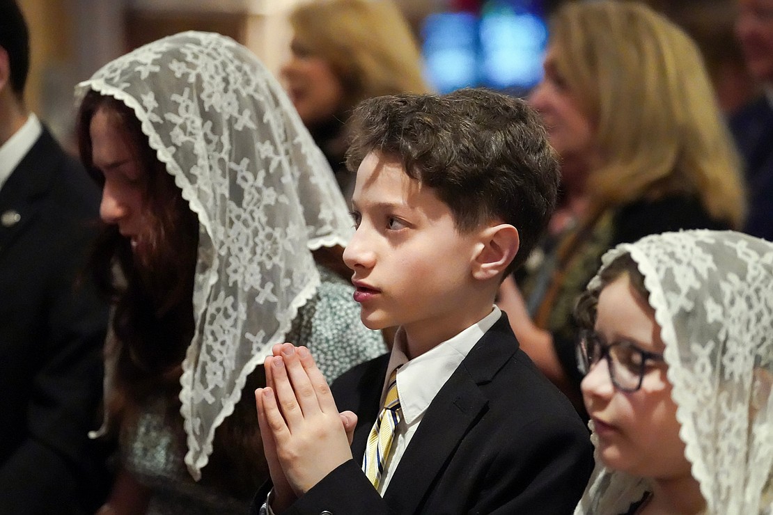 Nicholas DeSalvatore, 12, attends the Chrism Mass with his family on March 30 at the Cathedral of Immaculate Conception in Albany. (Cindy Schultz photo for The Evangelist)