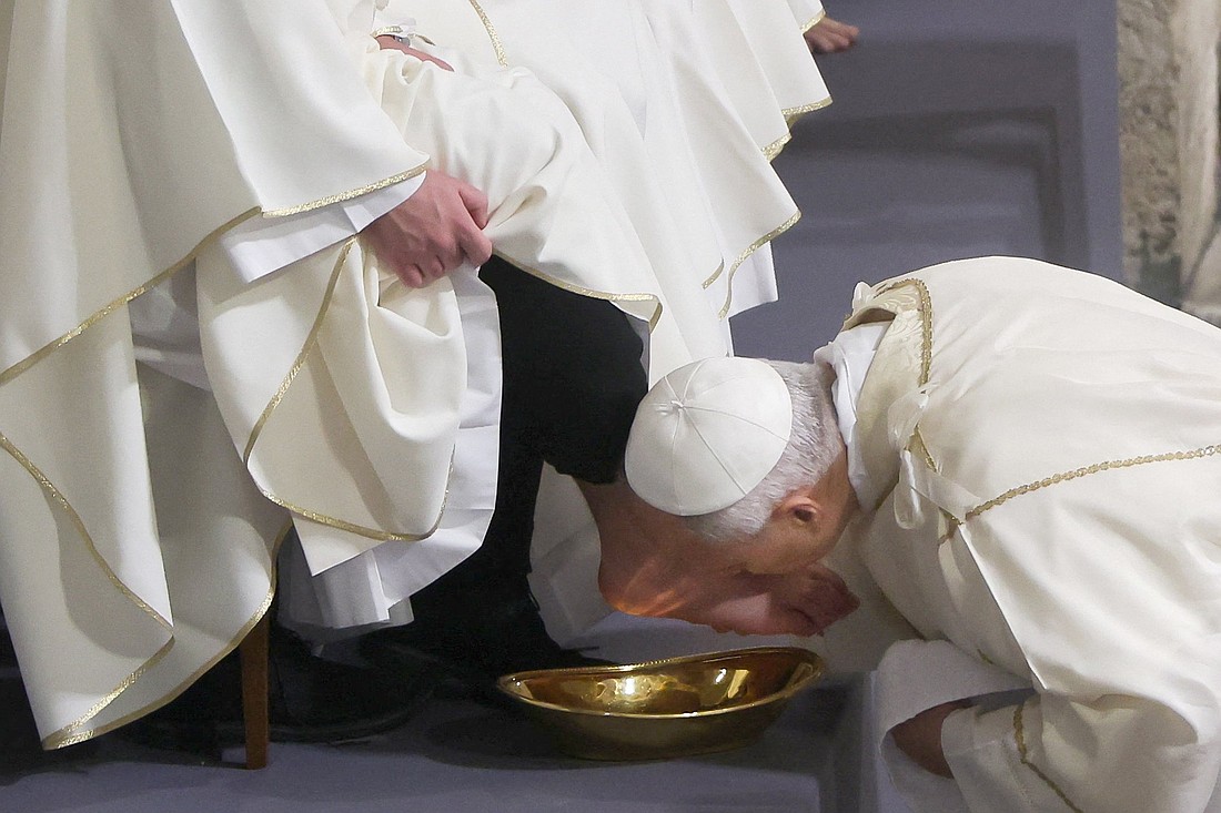 Pope Leo XIV kisses the foot of a clergyman after washing it as he celebrates the Holy Thursday Mass of the Lord's Supper in the Basilica of St. John Lateran at Vatican April 2, 2026. (OSV News photo/Vincenzo Livieri, Reuters)