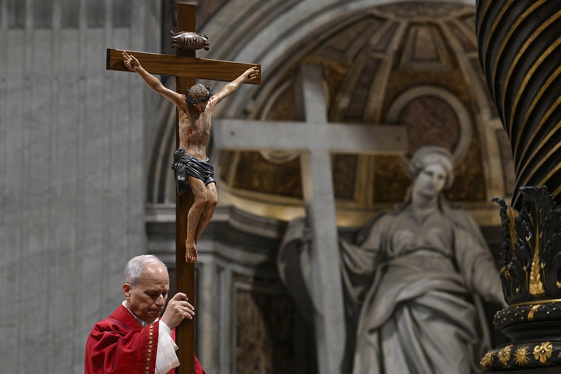 Pope Leo XVI holds a crucifix as he leads the Good Friday Liturgy of the Lord's Passion in St. Peter's Basilica at the Vatican April 3, 2026. (OSV News photo/Simone Risoluti, Vatican Media)