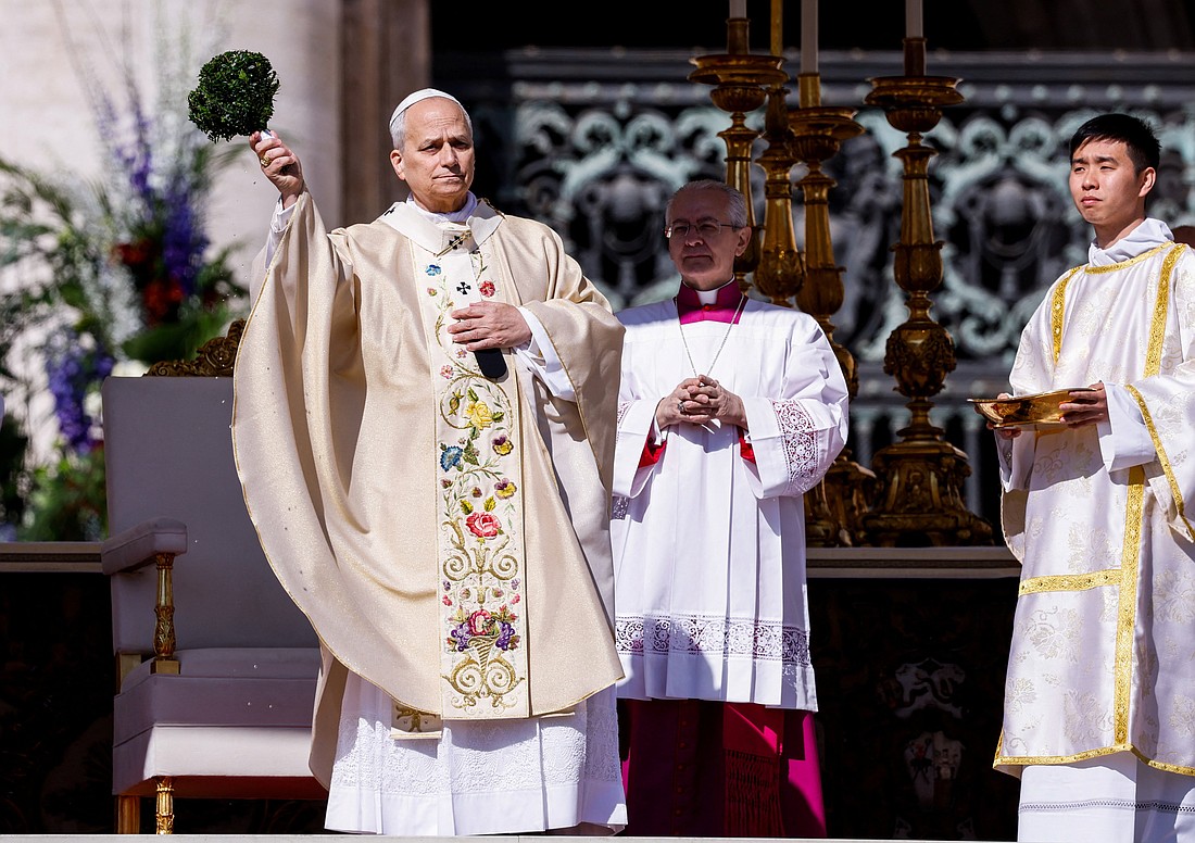 Pope Leo XIV blesses the thousands of the faithful gathered for Easter Mass in St. Peter's Square at the Vatican April 5, 2026. (OSV News photo/Remo Casilli, Reuters)