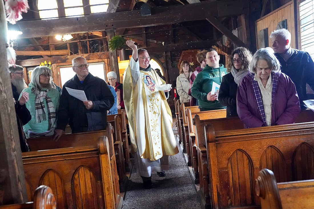 Father Michael Heine flicks holy water on parishiors during Easter Mass on Sunday, April 5, 2026, at the Saint Kateri Tekakwitha Shrine in Fonda, N.Y.  Cindy Schultz for The Evangelist
