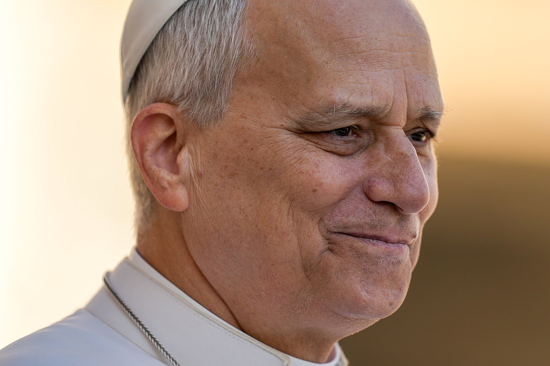 Pope Leo XIV smiles as he greets visitors and pilgrims from the popemobile while riding around St. Peter’s Square at the Vatican before his weekly general audience April 8, 2026. (CNS photo/Lola Gomez)