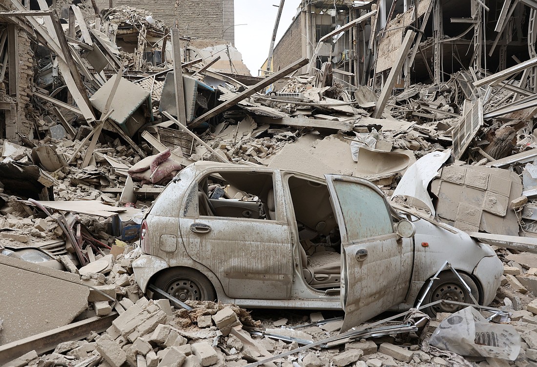 A destroyed vehicle is seen amid rubble at the site of a strike on a residential building in Tehran, Iran, March 16, 2026, amid the U.S.-Israeli war with Iran. (OSV News photo/Majid Asgaripour, WANA via Reuters) Editors: ATTENTION EDITORS - THIS PICTURE WAS PROVIDED BY A THIRD PARTY EDITORIAL USE ONLY
