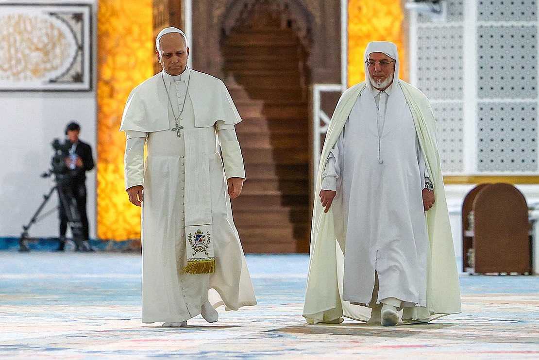 Pope Leo XIV walks with Mohammed Al-Mamoun Al-Qasimi Al-Hassani, rector of the Great Mosque of Algiers in Algiers, Algeria, April 13, 2026. The pontiff visited the mosque, one of the largest in the world, in a gesture aimed at reinforcing Christian-Muslim dialogue. (OSV News photo/Guglielmo Mangiapane, Reuters).