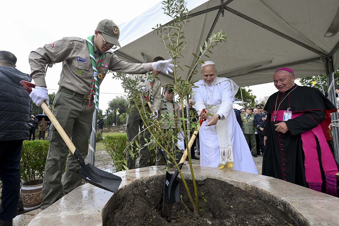 Pope Leo XIV is assisted by a Boy Scout as he visits the archaeological site of Hippo Regius in Annaba, Algeria, April 14, 2026. At right is Bishop Michel Guillaud of Constantine-Hippone in Algeria. (OSV News photo/Simone Risoluti, Vatican Media)
