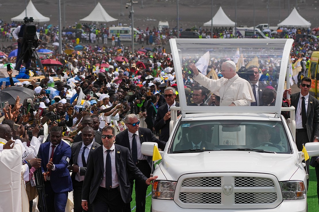 Pope Leo XIV waves to the crowds as he rides in the popemobile among the faithful as he arrives outside Japoma Stadium in Douala, Cameroon, April 17, 2026. (CNS photo/Lola Gomez)