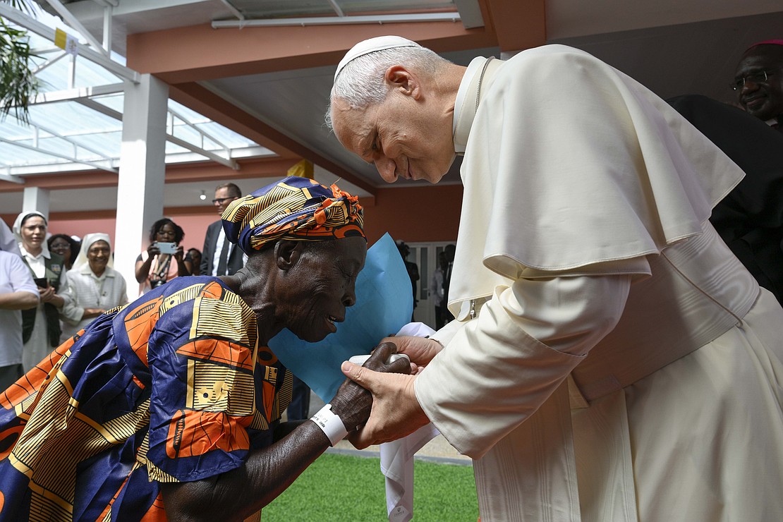 Pope Leo XIV greets an elderly woman as he visits a nursing home in Saurimo, Angola, April 20, 2026. (OSV News photo/Simone Risoluti, Vatican Media).
