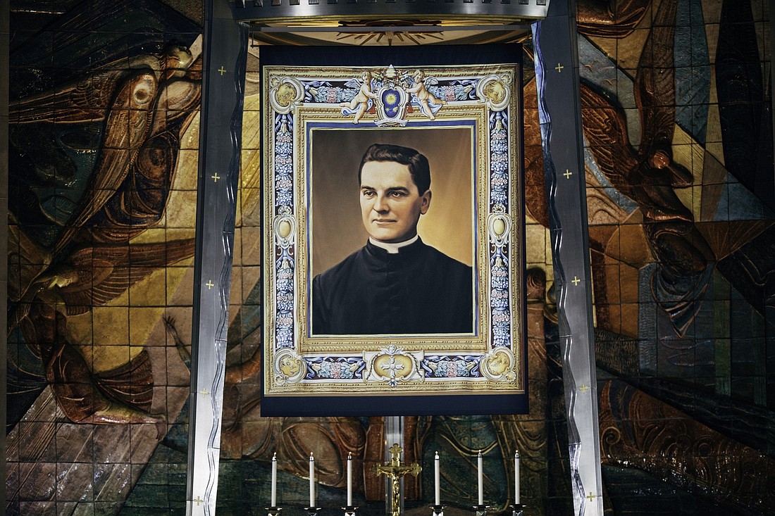 A giant tapestry with a portrait of Blessed Michael McGivney, founder of the Knights of Columbus, is seen during his beatification Mass Oct. 31, 2020, at the Cathedral of St. Joseph in Hartford, Conn. It was unveiled at the conclusion of the beatification rite at the start of the Mass. (CNS photo/courtesy Knights of Columbus)