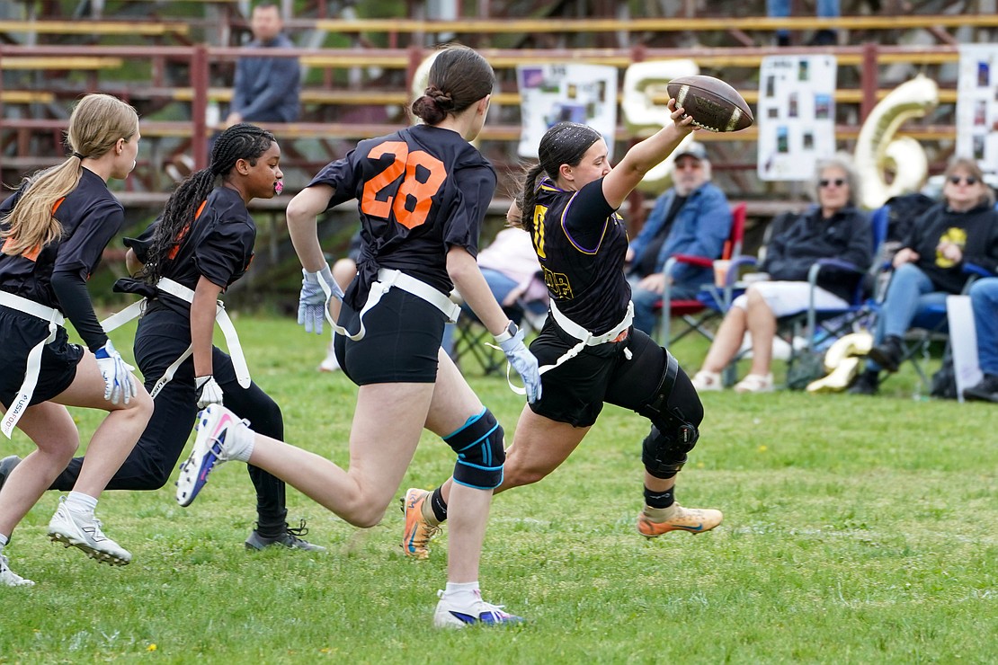 Holy Trinity quarterback Ella DiBacco holds the football high as she nears the end zone during the Pride's flag football game against Mohonasen on April 29 at Notre Dame-Bishop Gibbons School in Schenectady. Holy Trinity won 34-6. (Cindy Schultz photo for The Evangelist)