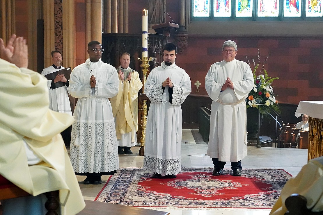 Gilbert Kimaro (from l.), Alessio Fasullo and Timothy Kilpeck are introduced as candidates for deacon during the Mass of Ordination to the Priesthood and the Diaconate on May 16 at the Cathedral of the Immaculate Conception in Albany. (Cindy Schultz photo for The Evangelist)