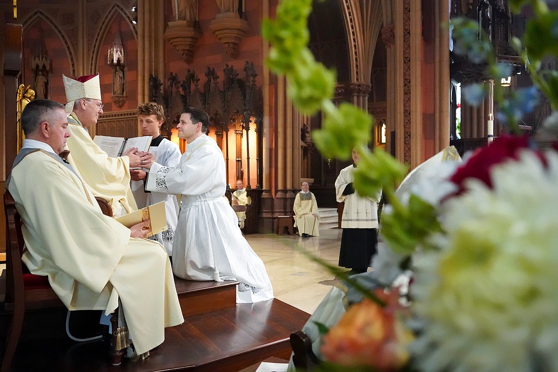 Candidate for the priesthood Alexander Turpin gives the promise of obedience to Bishop Mark O’Connell during the Mass of Ordination to the Priesthood and the Diaconate on May 16 at the Cathedral of the Immaculate Conception in Albany. (Cindy Schultz photo for The Evangelist)