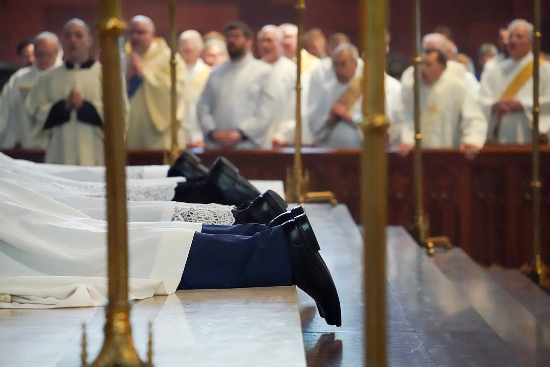 Candidates for the Ordination to the Priesthood and Diaconate lay in supplication on May 16 at the Cathedral of the Immaculate Conception in Albany. Cindy Schultz photo for The Evangelist)