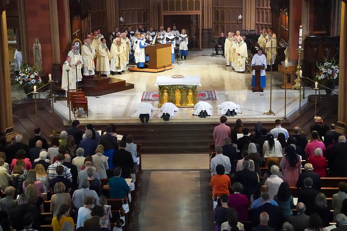 Candidates for the Ordination to the Priesthood and Diaconate lay in supplication on May 16 at the Cathedral of the Immaculate Conception in Albany. Cindy Schultz photo for The Evangelist)