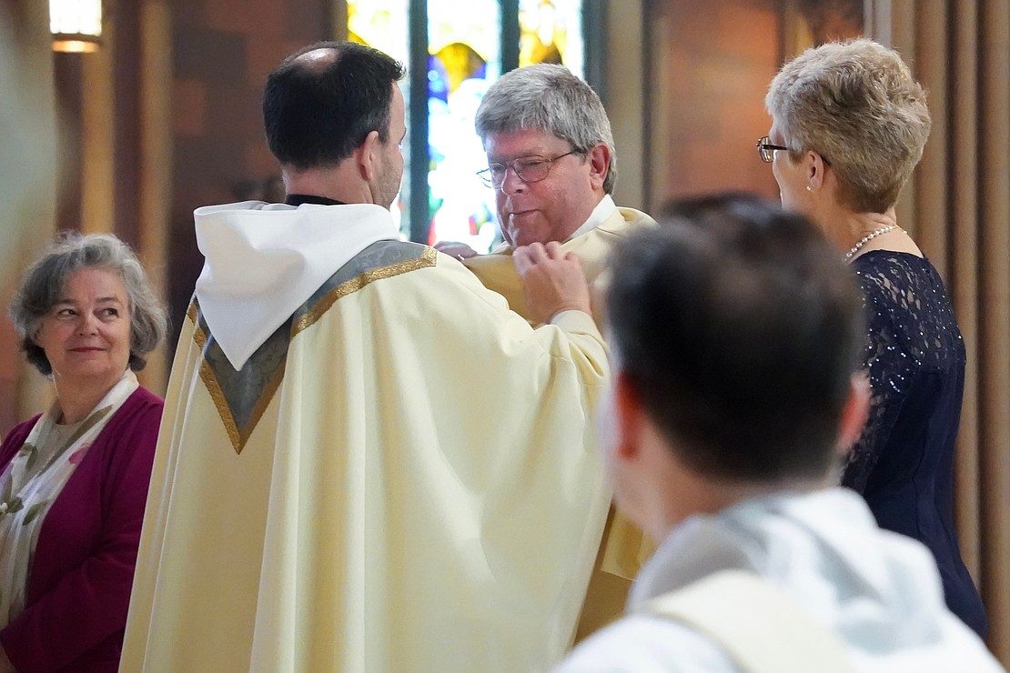 Newly ordained Deacon Timothy Kilpeck is vested with stole and chasuble during the Mass of Ordination to the Priesthood and Diaconate on May 16 at the Cathedral of the Immaculate Conception in Albany. (Cindy Schultz photo for The Evangelist)
