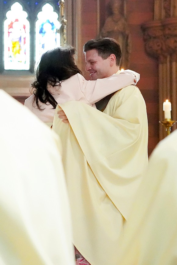 Newly ordained Father Alexander Turpin embraces his mother Carmela Turpin when he’s vested with stole and chasuble during the Mass of Ordination to the Priesthood and Diaconate on May 16 at the Cathedral of the Immaculate Conception in Albany. (Cindy Schultz photo for The Evangelist)
