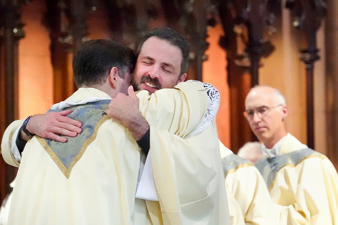 Father Dan McHale of St. Edward the Confessor 9c.) welcomes newly ordained Father Alexander Turpin into the priesthood during the Mass of Ordination to the Priesthood and Diaconate on May 16 at the Cathedral of the Immaculate Conception in Albany. (Cindy Schultz photo for The Evangelist)