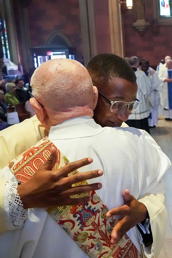 Newly ordained Deacon Gilbert Kimaro is welcomed into his new role during the Mass of Ordination to the Priesthood and Diaconate on May 16 at the Cathedral of the Immaculate Conception in Albany. (Cindy Schultz photo for The Evangelist)